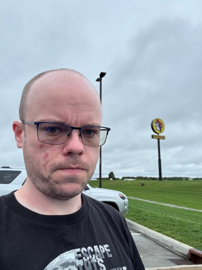 Mike Tarpey takes a selfie near the end of the road trip in front of the large Buc-ee's sign that overlooks Interstate 75 in Richmond, Kentucky.